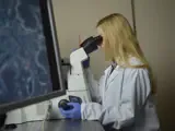 Student Studying Forensic Science With Microscope